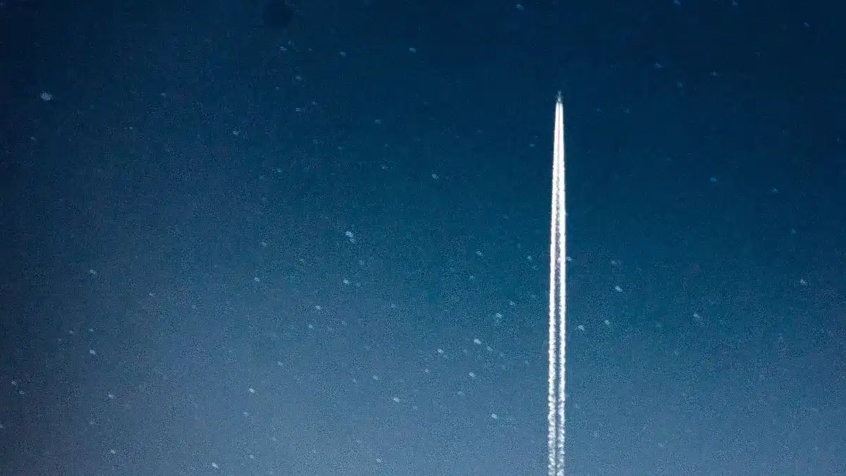 Business growth visualized by a rocket-like airplane ascending into the night sky. Article: Forget Hustle – It’s Satisfaction That Drives Long-Term Success by Henrik Wenoe